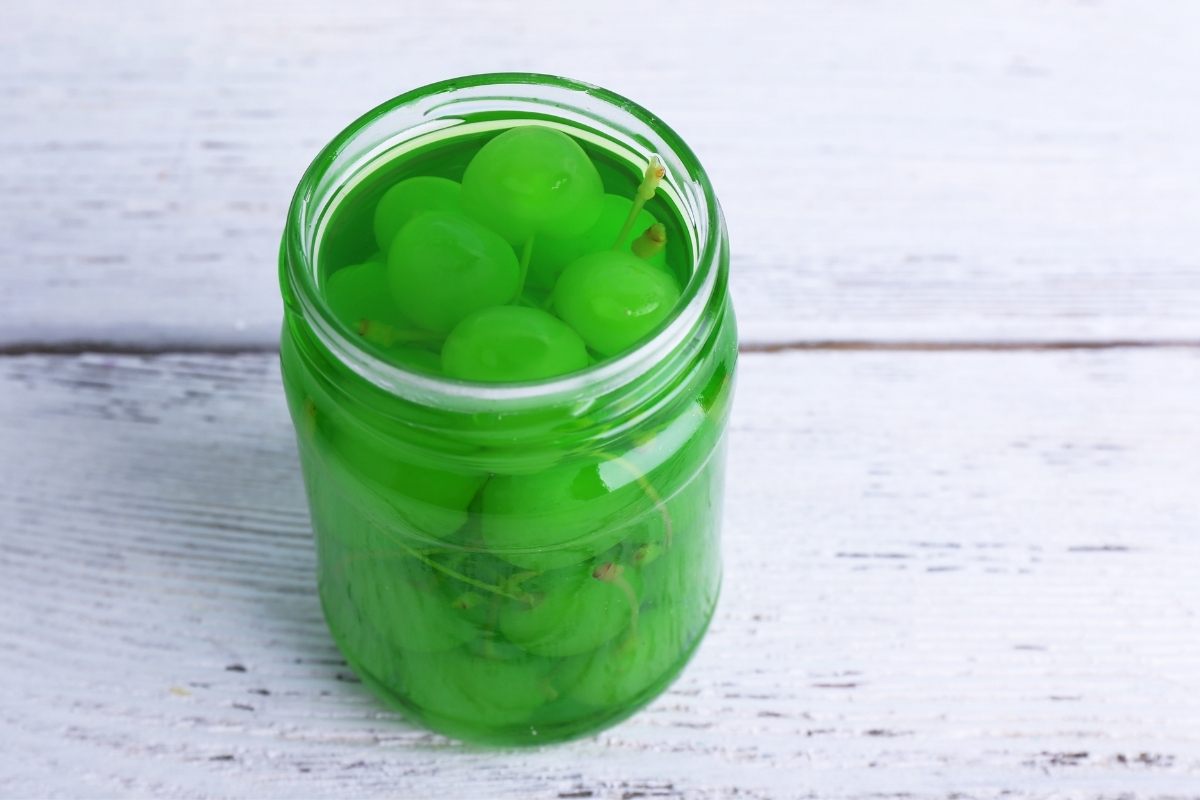 A jar of green Maraschino cherries. These green cherries in a jar were made at home.