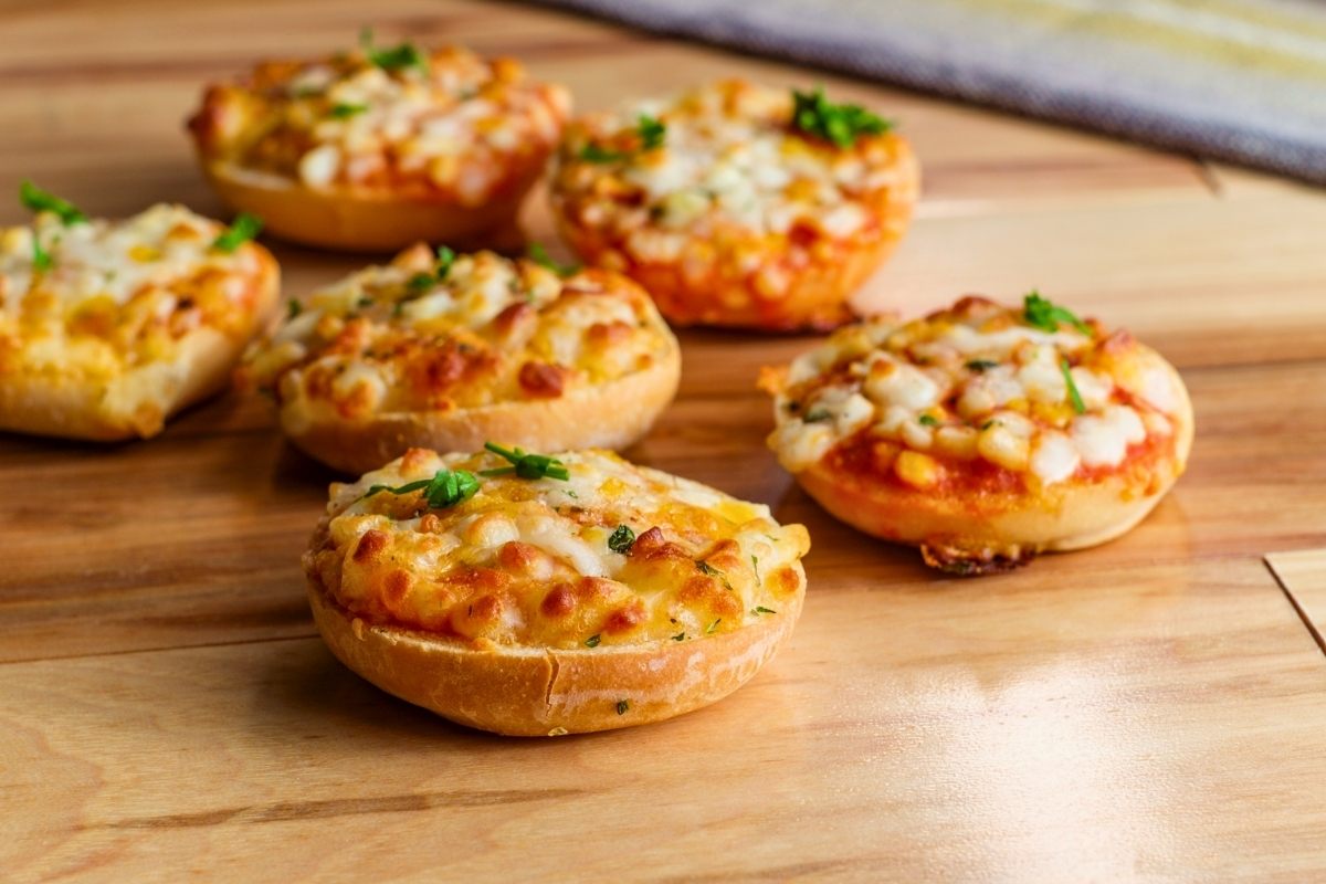 Simple pizza bagels with tomato sauce, cheese and veggies.