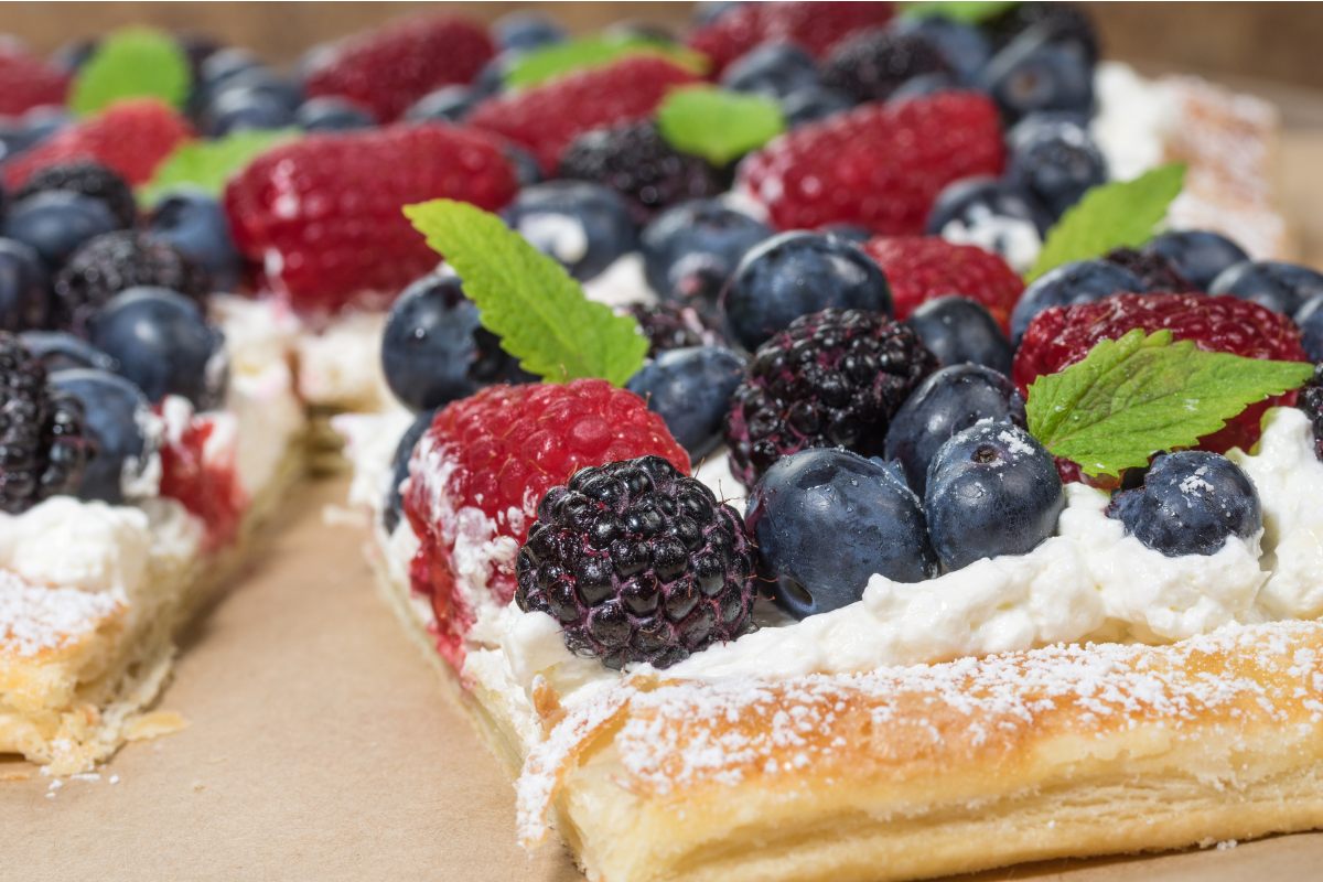 Berry tart with a puff pastry base, whipped cream and summer berries.