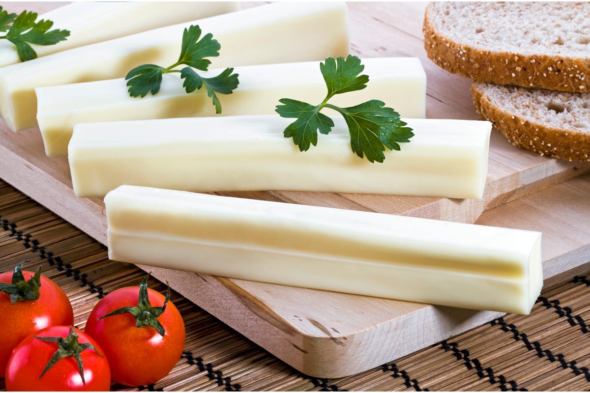 Cheddar cheese sticks, bread and baby tomatoes.