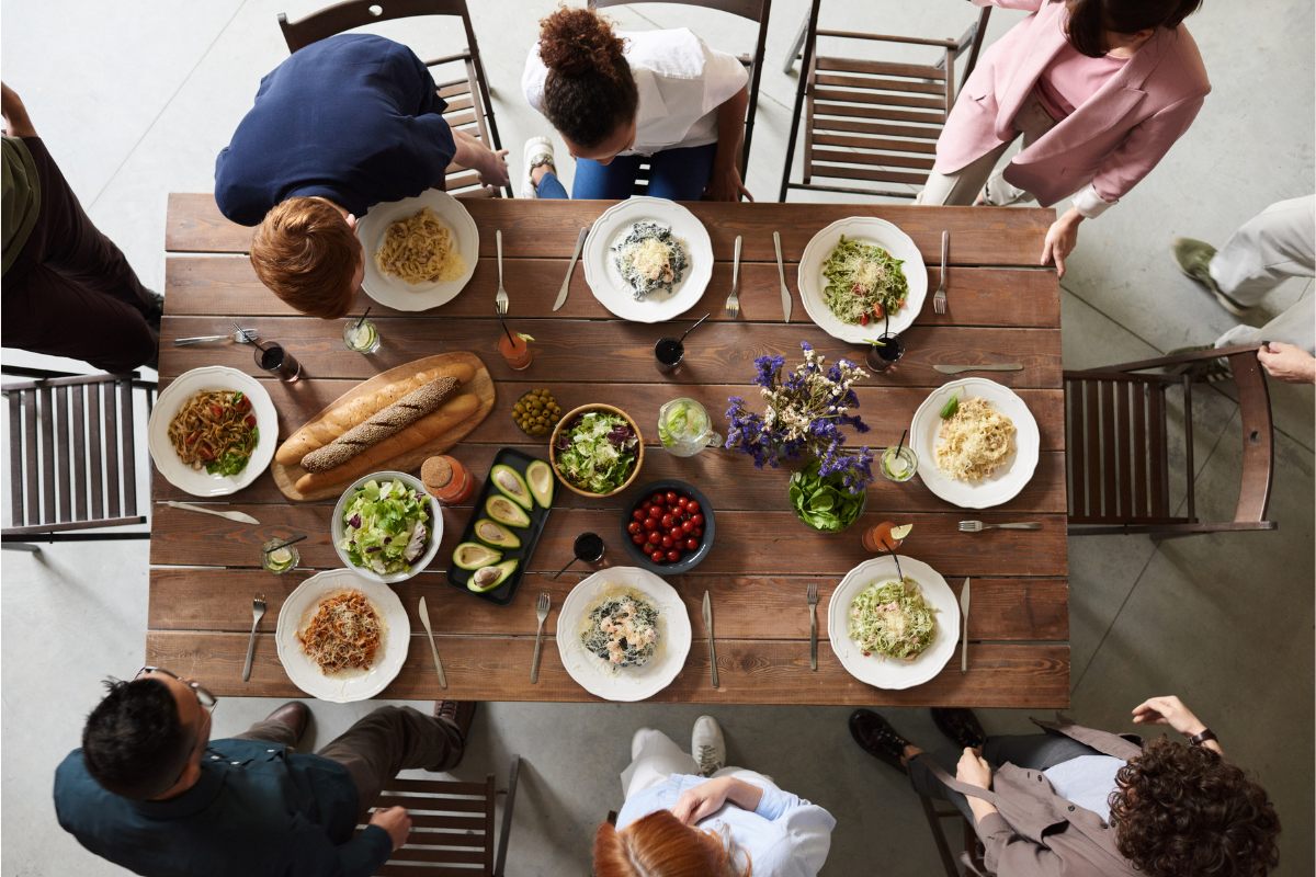 Family sitting down to a pasta dinner.