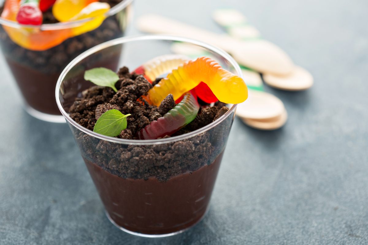 Two dirt cups with colorful gummy worms.