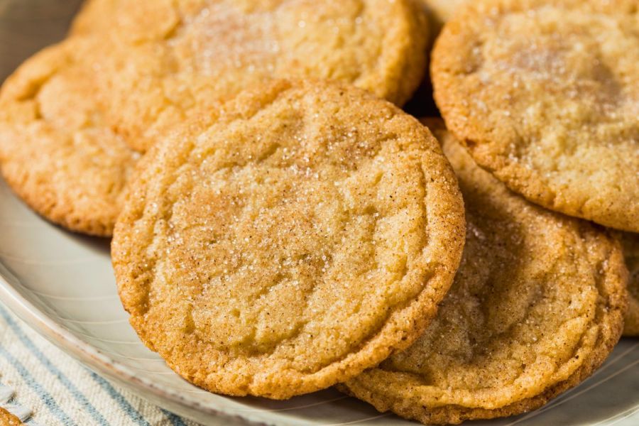 Close-up of homemade snickerdoodle cookies with cinnamon sugar on a plate.