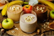 Three glasses of chocolate nut butter smoothie with different amounts of cocoa powder.